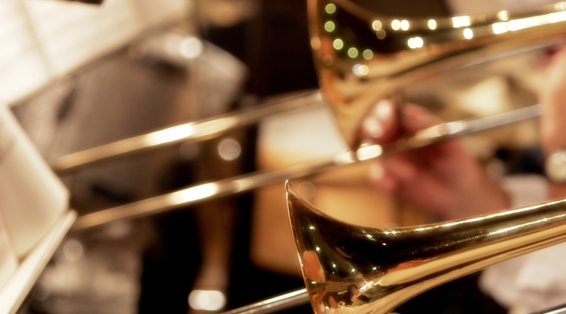 trombones playing live in a big band (shallow focus).