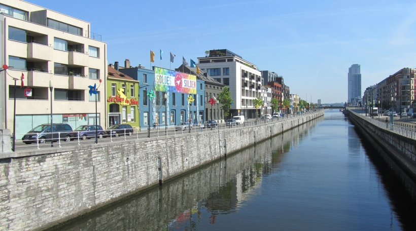 BRUSSELS, BELGIUM, JULY 4 2015: The canal and quai de charbonnages in sint jans molenbeek in Brussels. Part of the Brussels capital region it is home to Toots Thieleman and a large muslim community. BRUSSELS, BELGIUM, JULY 4 2015: The canal and quai de charbonnages in sint jans molenbeek in Brussels. Part of the Brussels capital region it is home to Toots Thieleman and a large muslim community.