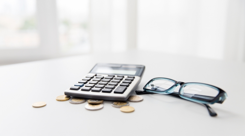 busines, finance, money and bookkeeping concept - calculator, eyeglasses and euro coins on office table busines, finance, money and bookkeeping concept - calculator, eyeglasses and euro coins on office table