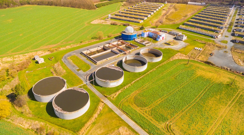 Aerial view to biogas plant from pig farm in green fields. Renewable energy from biomass. Modern agriculture in Czech Republic and European Union. Aerial view to biogas plant from pig farm in green fields. Renewable energy from biomass. Modern agriculture in Czech Republic and European Union.