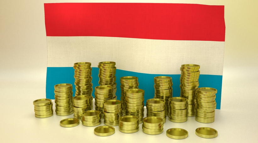 finance concept with Luxembourgeois national flag and golden coins